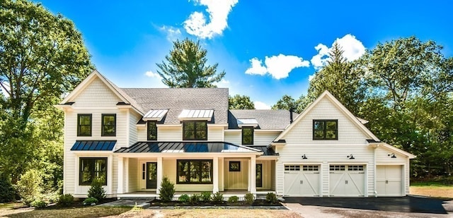 modern farmhouse style home featuring a porch and a garage