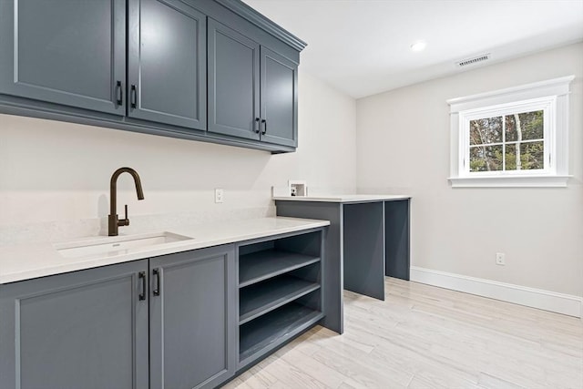 interior space featuring sink and light wood-type flooring