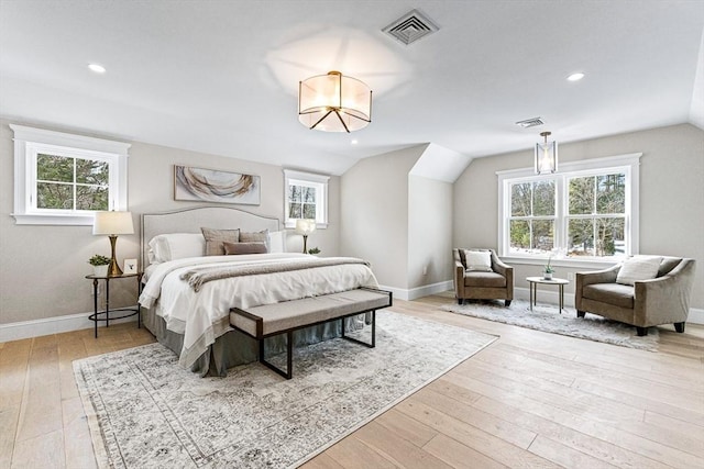 bedroom featuring lofted ceiling and light hardwood / wood-style flooring