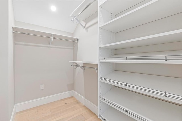 walk in closet with hardwood / wood-style floors