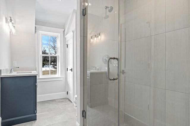 bathroom featuring toilet, vanity, and an enclosed shower