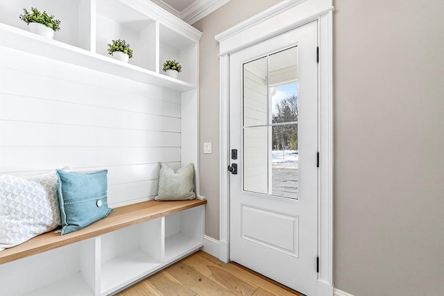 mudroom featuring crown molding and light hardwood / wood-style flooring