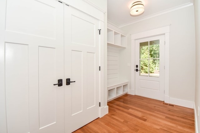 mudroom featuring ornamental molding and light hardwood / wood-style floors