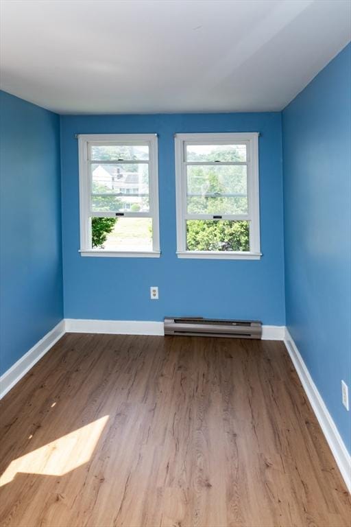 286 Fisher St, Walpole, MA 02081 - spare room with a baseboard radiator, wood finished floors, and plenty of natural light