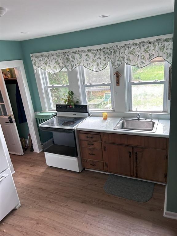 286 Fisher St, Walpole, MA 02081 - kitchen featuring electric stove, light wood-style floors, and light countertops