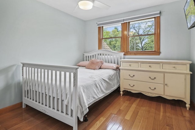 bedroom with hardwood / wood-style floors and a ceiling fan