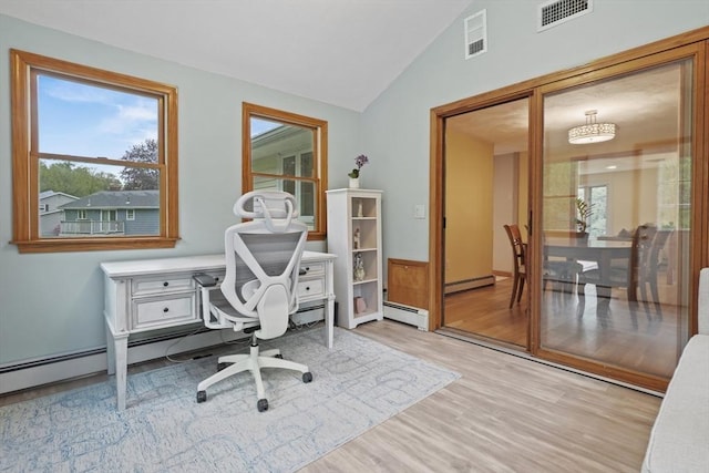 office space with baseboard heating, wood finished floors, and lofted ceiling