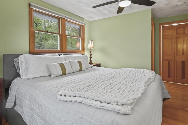 bedroom featuring wood finished floors and a ceiling fan