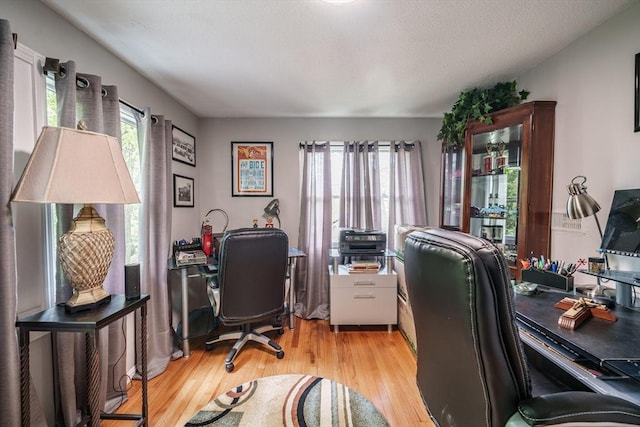 home office with light wood-style flooring