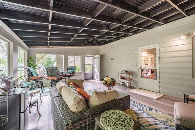 living room featuring wood finished floors and wooden walls
