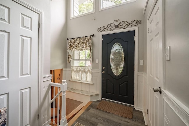 entryway with wainscoting, wood finished floors, and a decorative wall