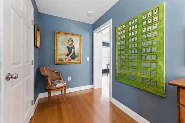doorway to outside featuring baseboards and wood finished floors