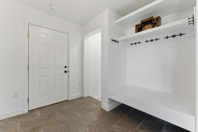 mudroom with baseboards and stone finish flooring