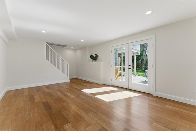 doorway with french doors, light wood-type flooring, stairway, baseboards, and recessed lighting