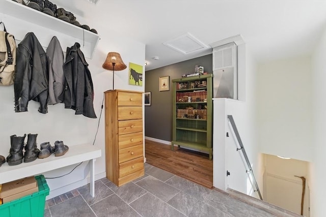 mudroom featuring baseboards and attic access