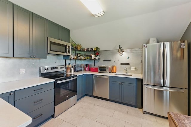 kitchen featuring a sink, light countertops, and stainless steel appliances
