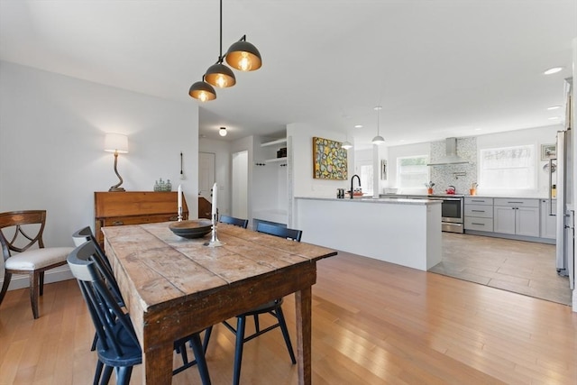 dining area featuring recessed lighting and light wood finished floors