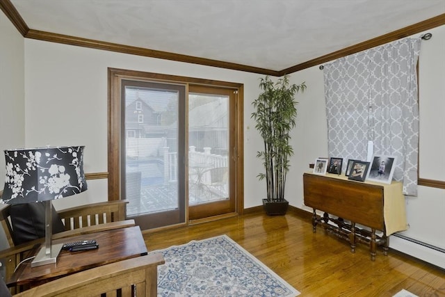 doorway to outside featuring baseboards, ornamental molding, and wood finished floors