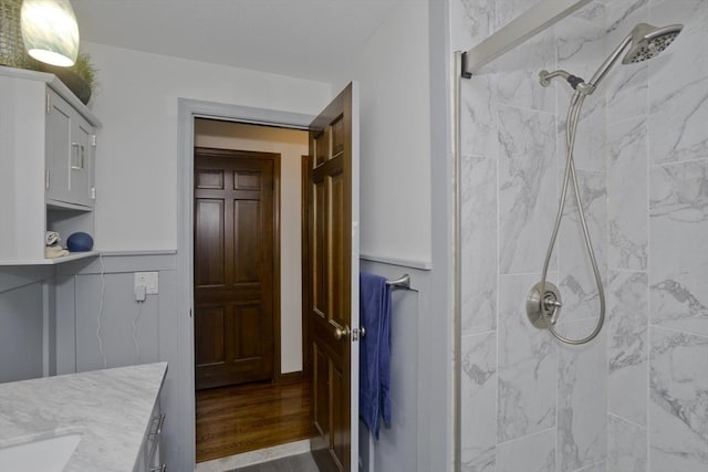 full bathroom with vanity and a marble finish shower