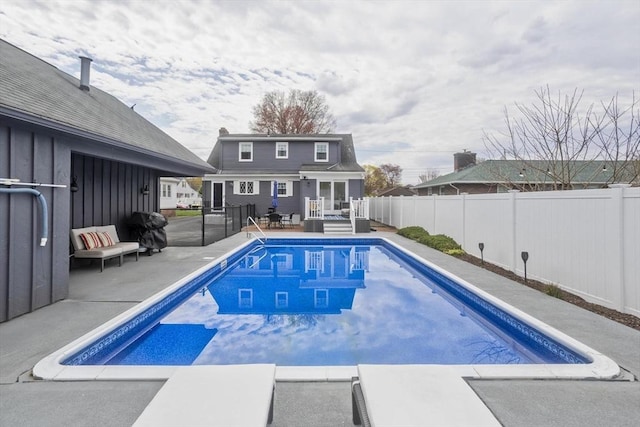 view of pool with a fenced in pool, a patio, a fenced backyard, and a deck