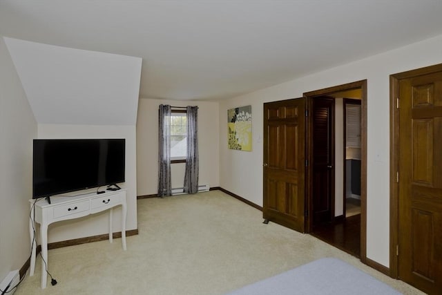 bedroom featuring baseboards, baseboard heating, and carpet