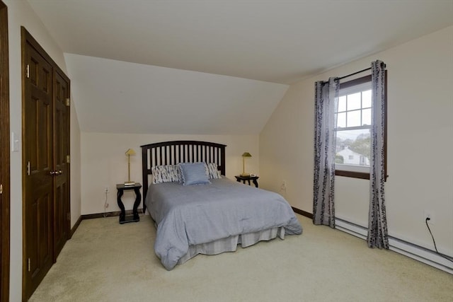 carpeted bedroom featuring baseboards and vaulted ceiling
