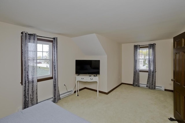 bedroom with baseboards, multiple windows, baseboard heating, and light colored carpet