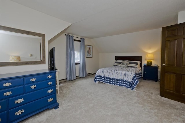 bedroom with lofted ceiling and light carpet