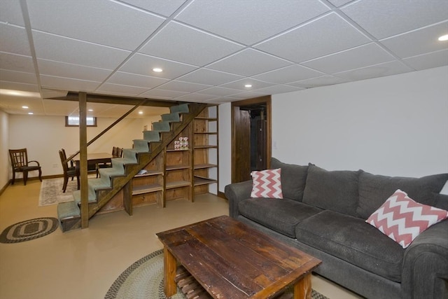 living room featuring recessed lighting, baseboards, a paneled ceiling, and stairway