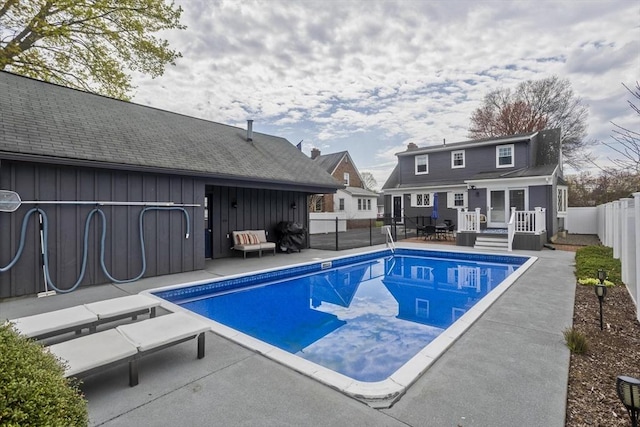 view of swimming pool featuring a fenced in pool, a fenced backyard, a deck, and a patio