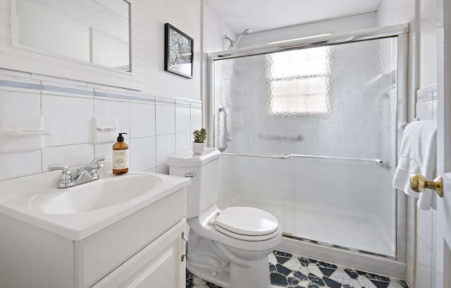 bathroom with toilet, a shower stall, tile walls, and vanity