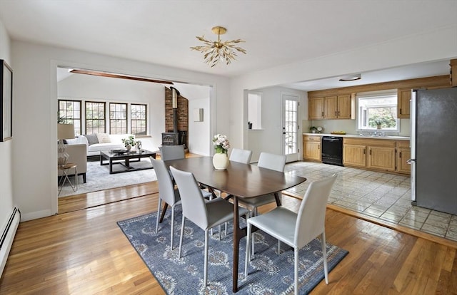 dining area featuring light wood-style flooring and baseboards