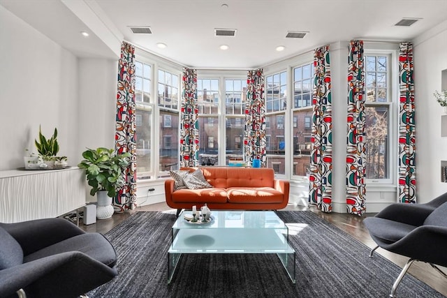 sitting room featuring visible vents and wood finished floors