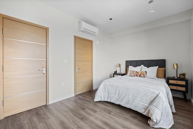 33 Copeland Unit F, Boston, MA 02119 - bedroom with a wall mounted air conditioner and wood finished floors