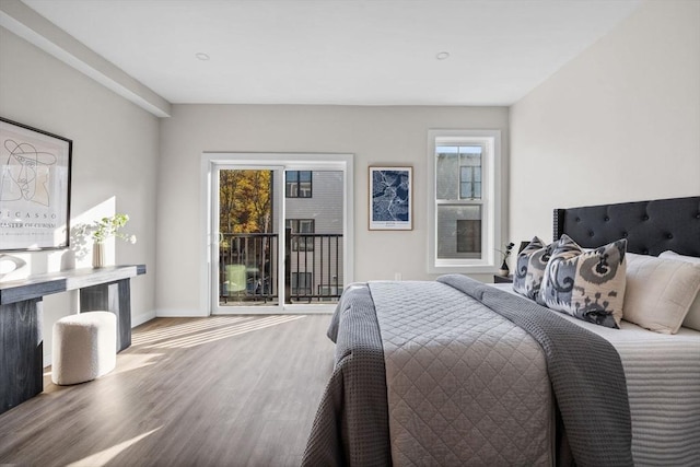 33 Copeland Unit F, Boston, MA 02119 - bedroom with access to outside, multiple windows, and wood finished floors