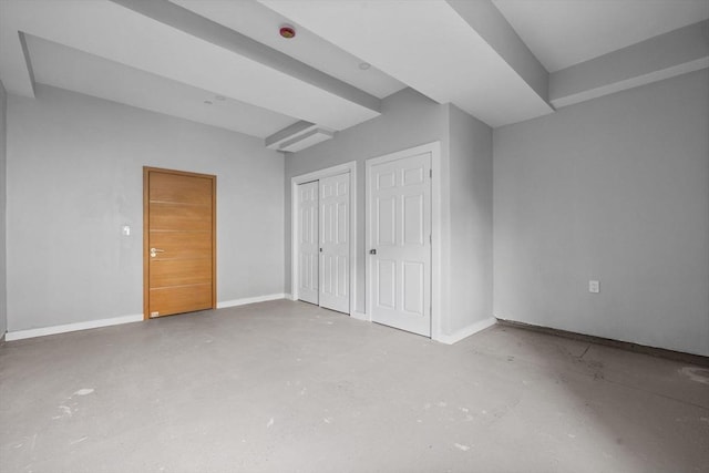 33 Copeland Unit F, Boston, MA 02119 - unfurnished bedroom featuring baseboards and concrete flooring