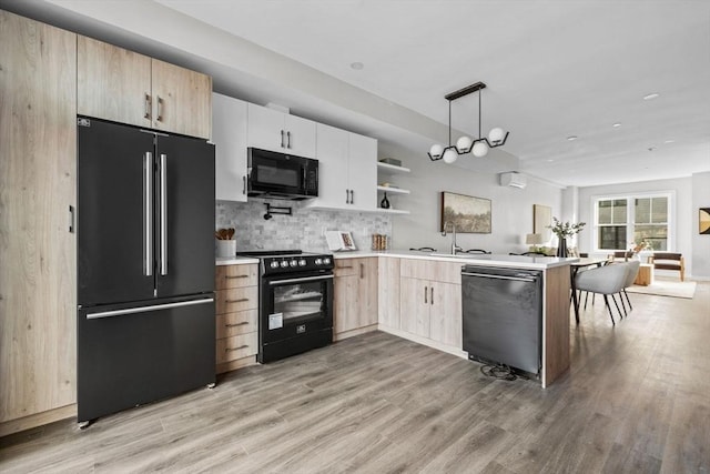 33 Copeland Unit F, Boston, MA 02119 - kitchen with black appliances, light brown cabinets, light countertops, and light wood finished floors