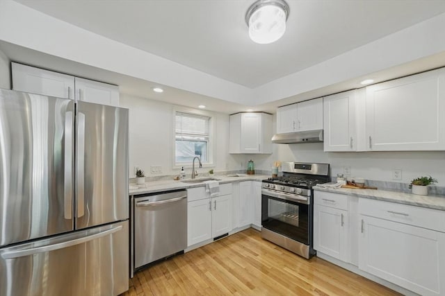 30 Balfour St, Boston, MA 02125 - kitchen with stainless steel appliances, under cabinet range hood, white cabinets, light stone counters, and light wood-style flooring