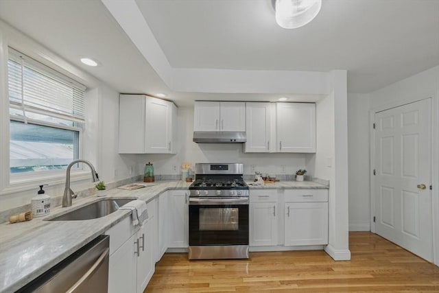 30 Balfour St, Boston, MA 02125 - kitchen featuring stainless steel appliances, a sink, under cabinet range hood, white cabinetry, and light stone countertops