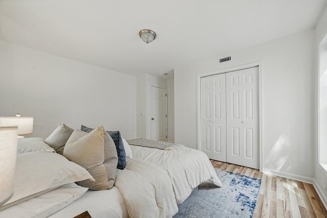 30 Balfour St, Boston, MA 02125 - bedroom featuring light wood-type flooring, baseboards, and a closet
