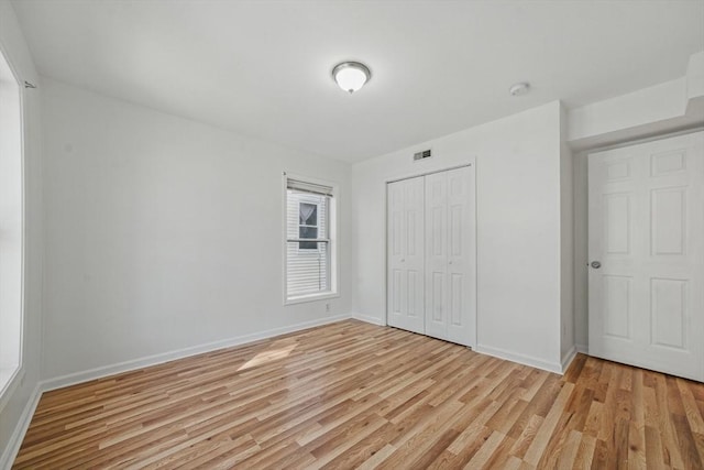 30 Balfour St, Boston, MA 02125 - unfurnished bedroom with light wood finished floors, a closet, and baseboards