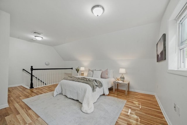 30 Balfour St, Boston, MA 02125 - bedroom with baseboards, light wood-style floors, and lofted ceiling