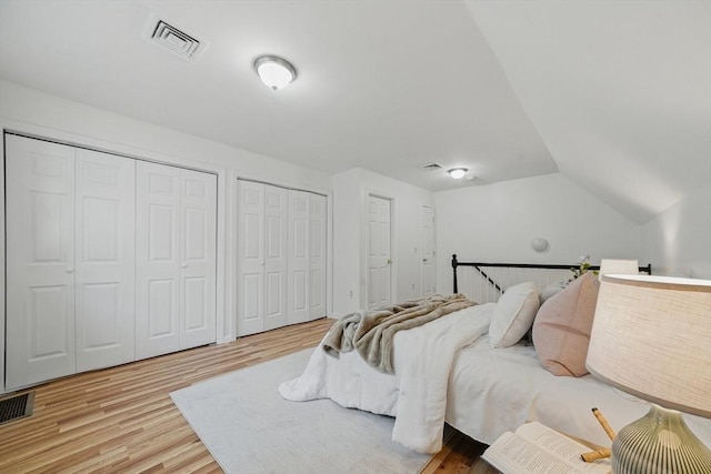 30 Balfour St, Boston, MA 02125 - bedroom featuring multiple closets, wood finished floors, and vaulted ceiling