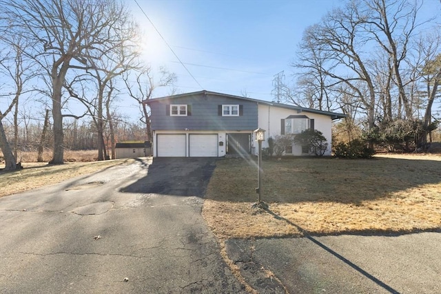 view of front of property featuring a garage and a front yard