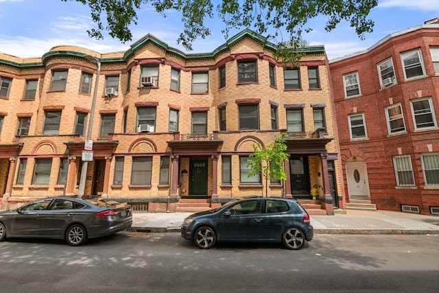 30 Edgerly Unit 4, Boston, MA 02115 - view of property featuring brick siding, cooling unit, and entry steps