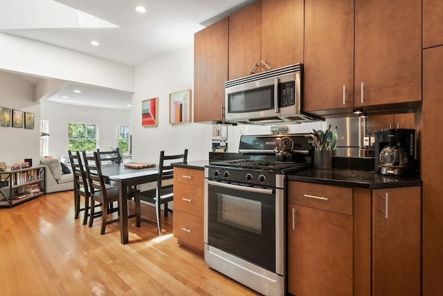 30 Edgerly Unit 4, Boston, MA 02115 - kitchen with stainless steel appliances, light wood finished floors, recessed lighting, brown cabinets, and open floor plan