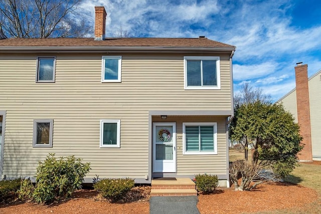 view of front of house featuring a chimney