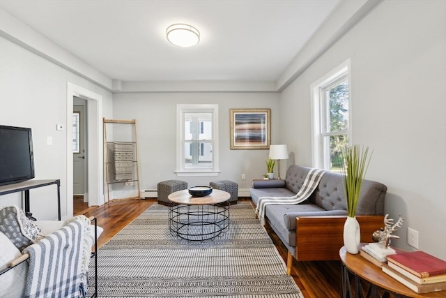 living area with hardwood / wood-style flooring and baseboard heating