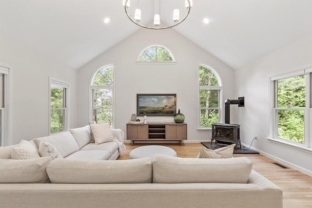 3 Misty Ln, Westford, MA 01886 - living area with a wood stove, a chandelier, light wood-style floors, high vaulted ceiling, and recessed lighting