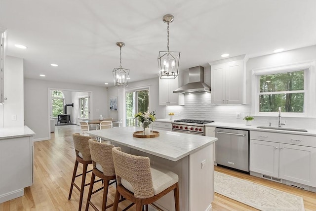 3 Misty Ln, Westford, MA 01886 - kitchen featuring wall chimney range hood, stainless steel appliances, a sink, light wood-type flooring, and recessed lighting